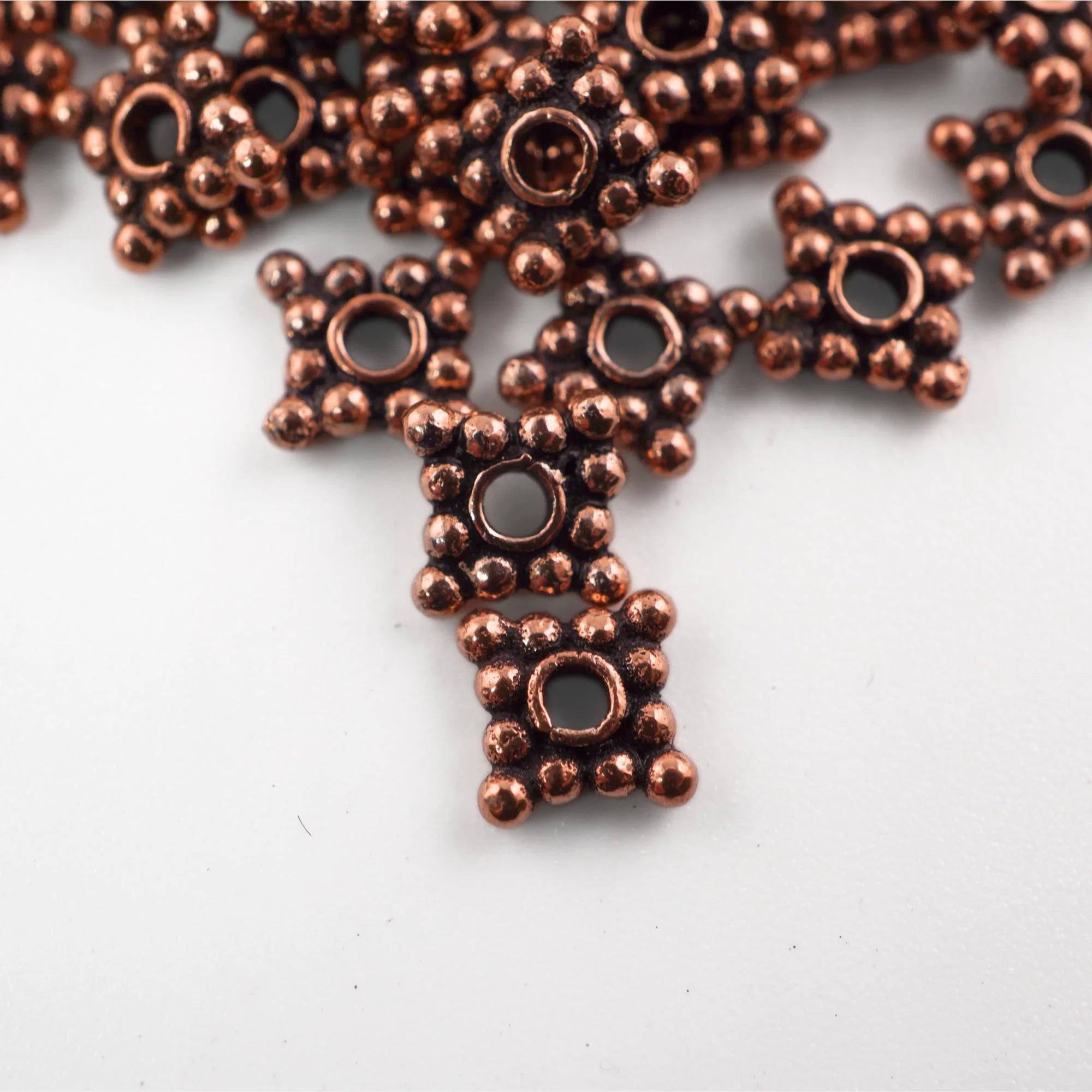 Antique copper square daisy bead close-up