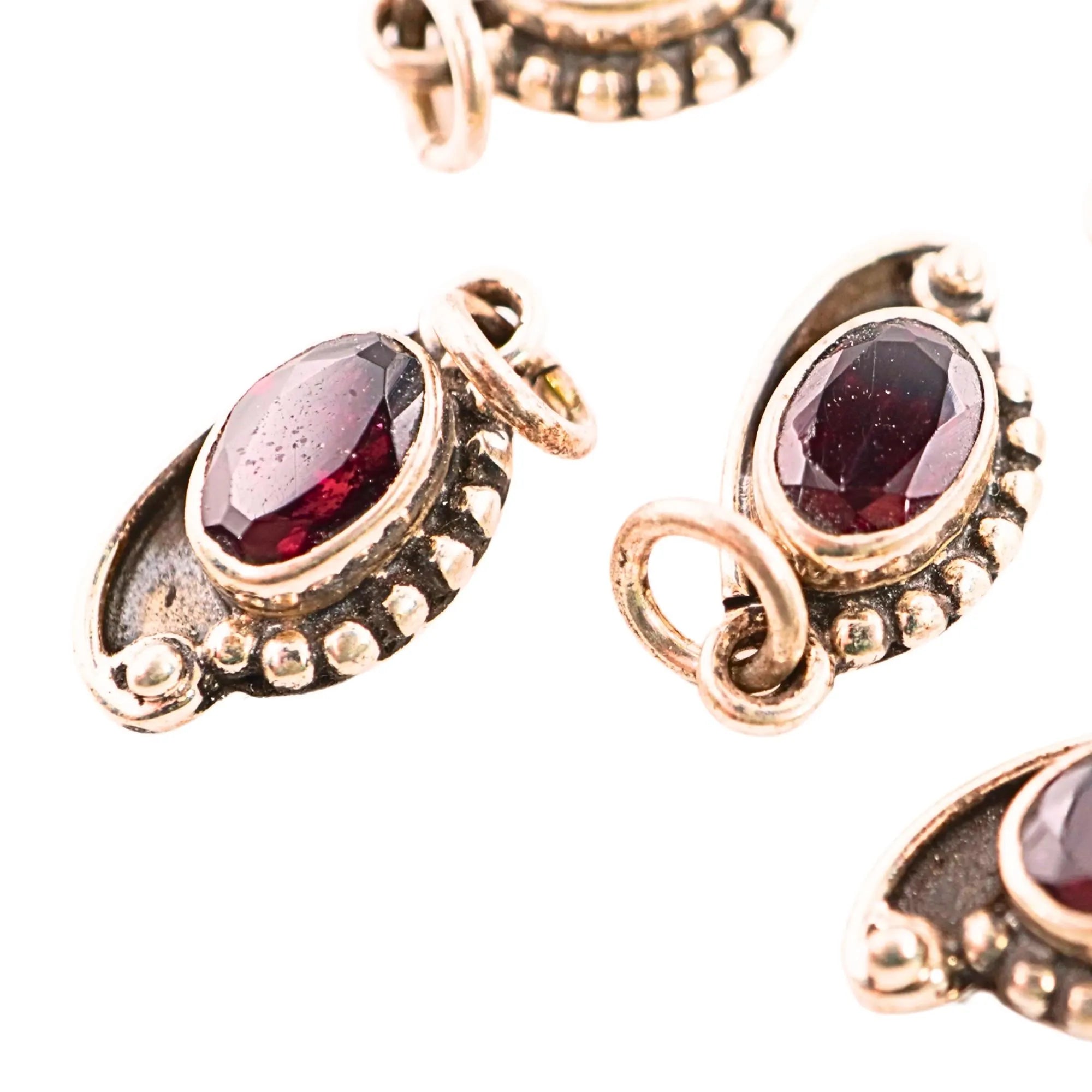 Handmade sterling silver charm with garnet