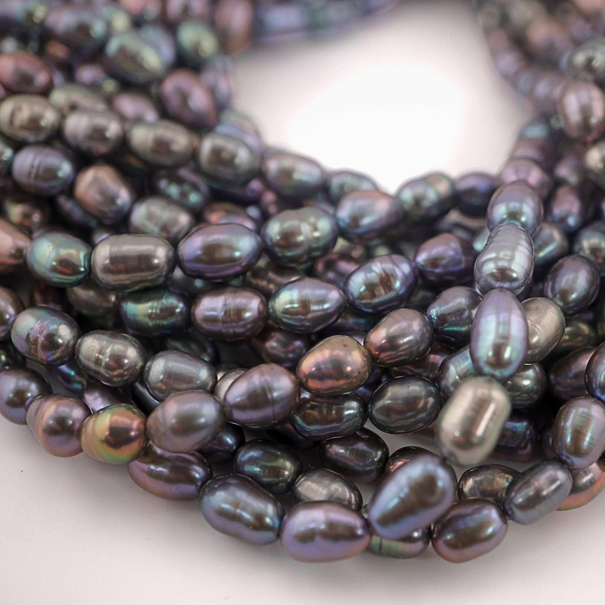 Natural peacock colored oval beads