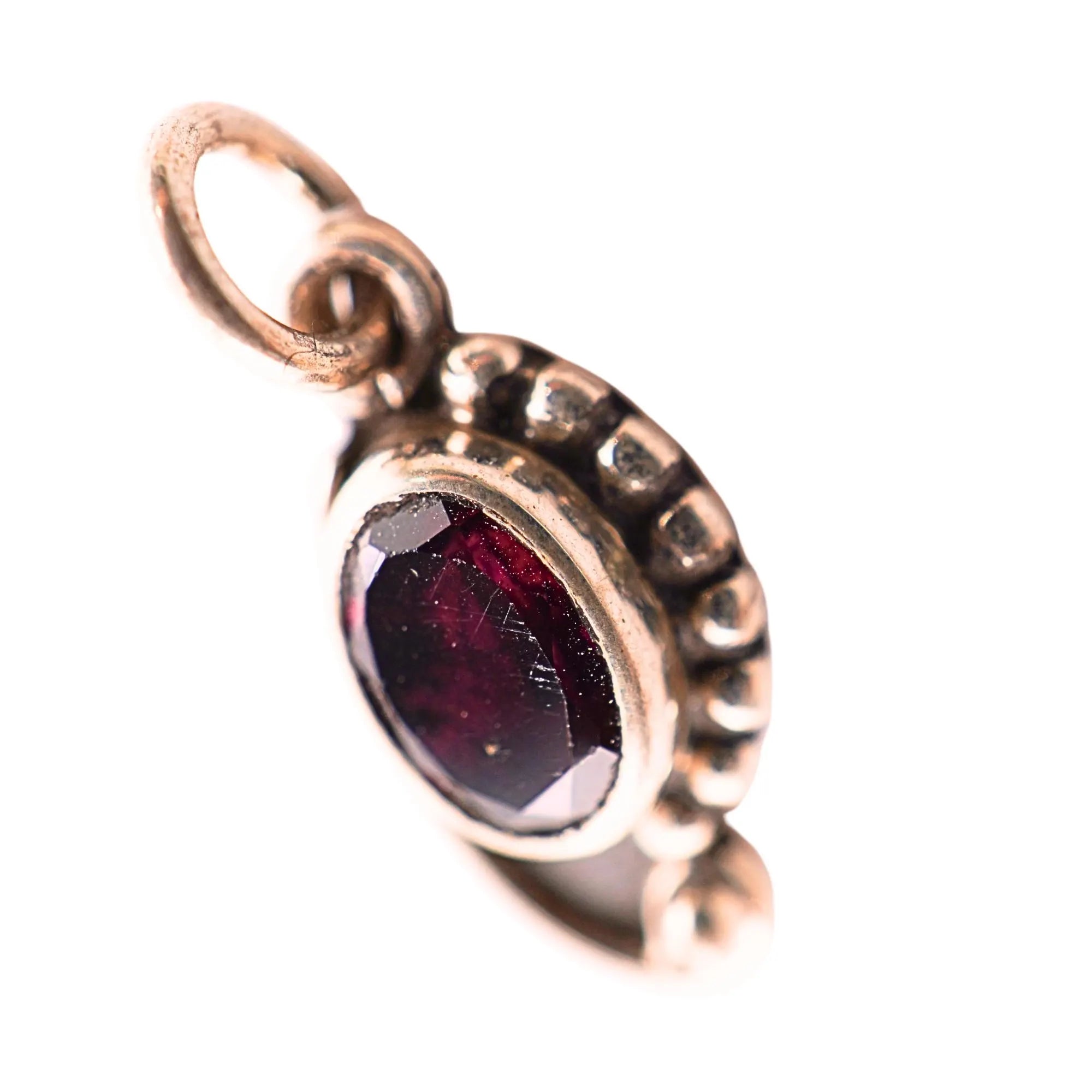 Oxidized vintage silver pendant with red gemstone