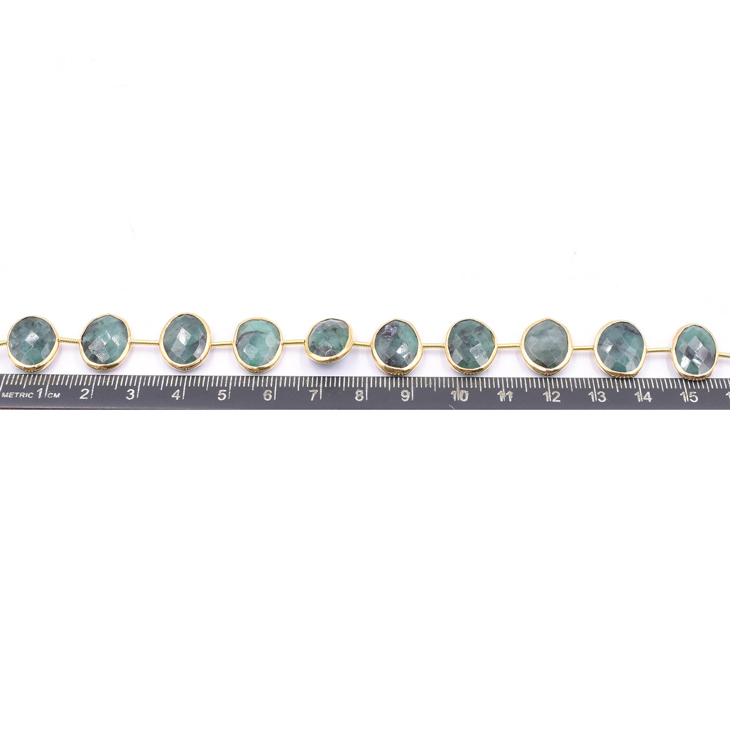 Unique raw emerald strand with oval gemstones