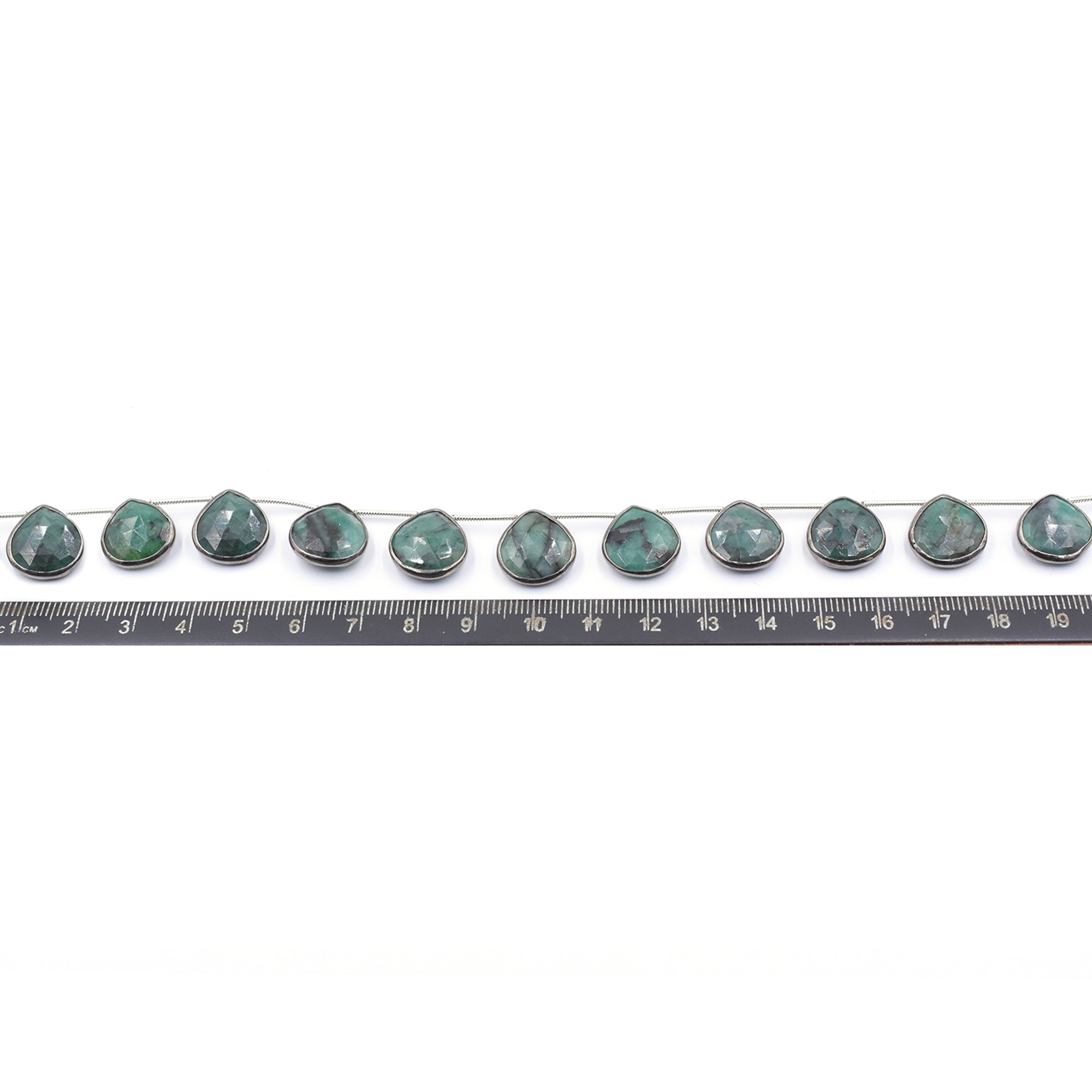 Raw emerald heart pendant with silver bezel and black plating