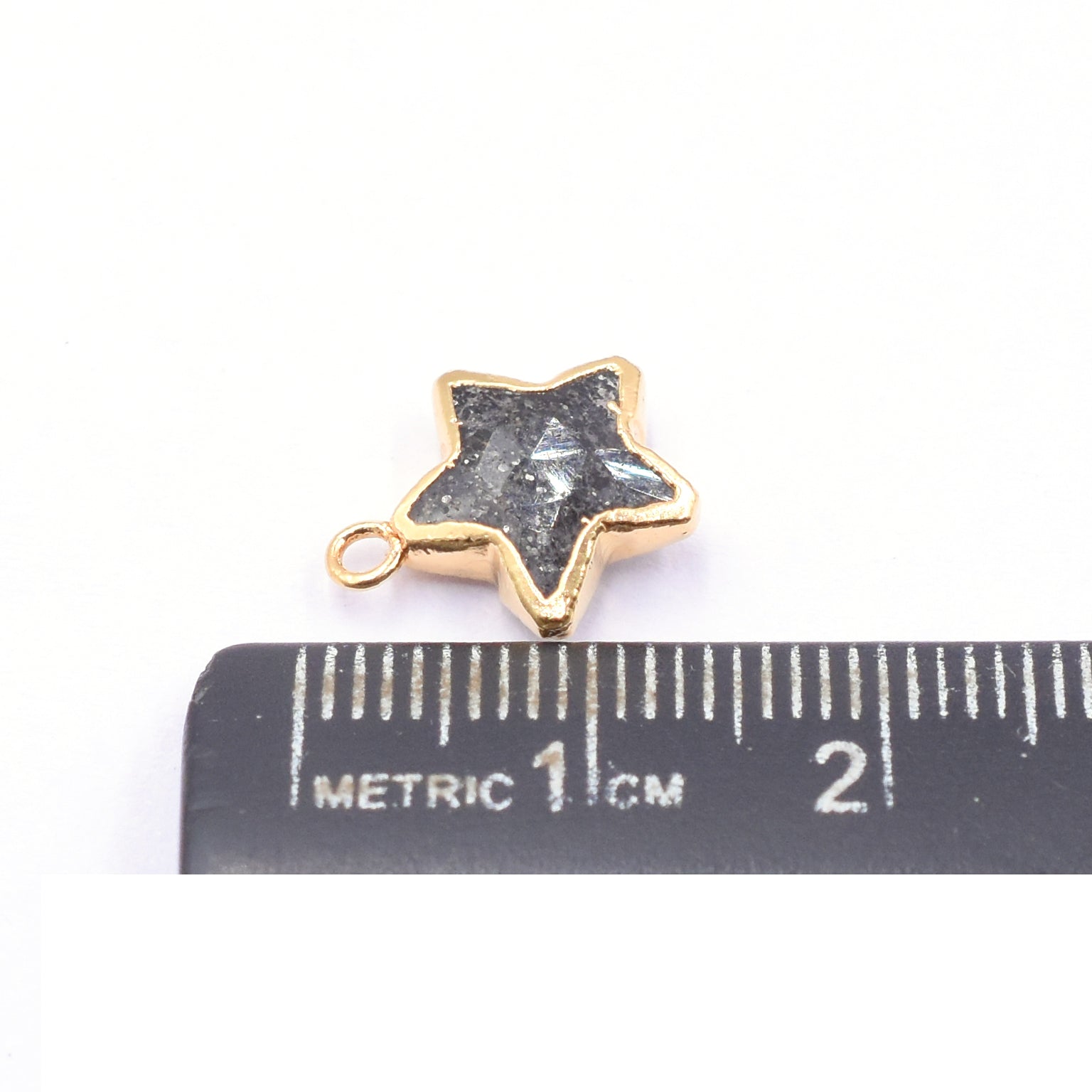 Unique Black Sunstone star-shaped pendant with gold detailing