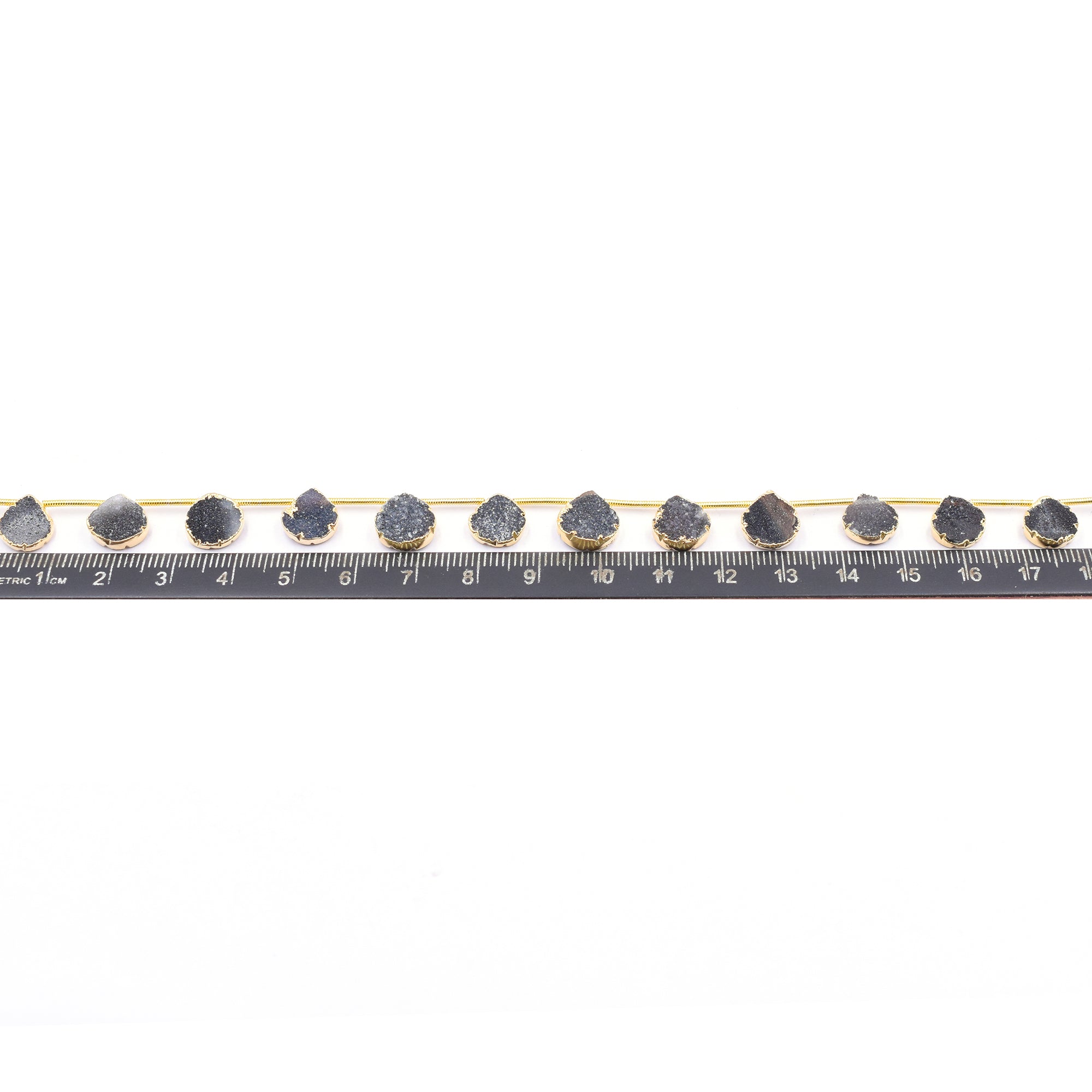 Unique black druzy stones with gold finish on a strand