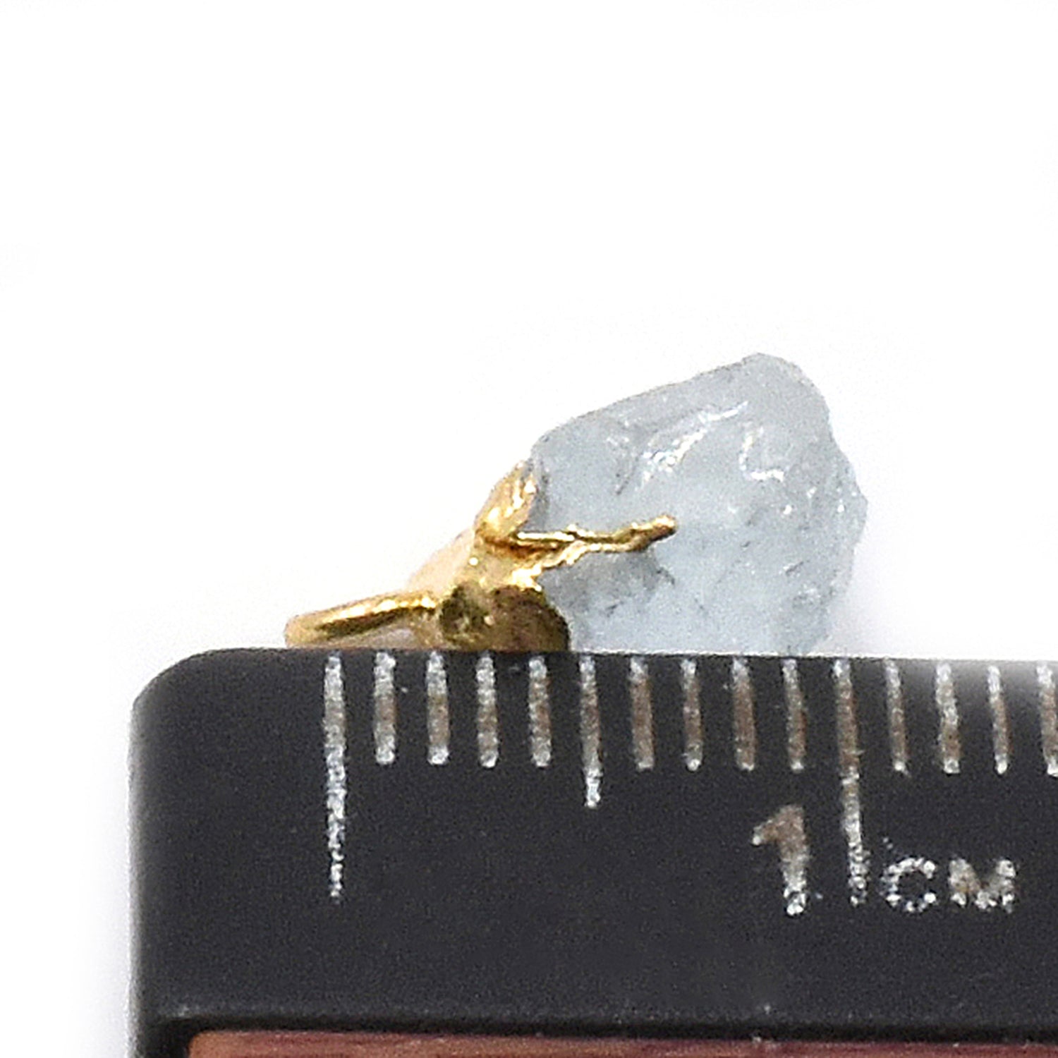 Vibrant aquamarine pendant shaped like an Rough