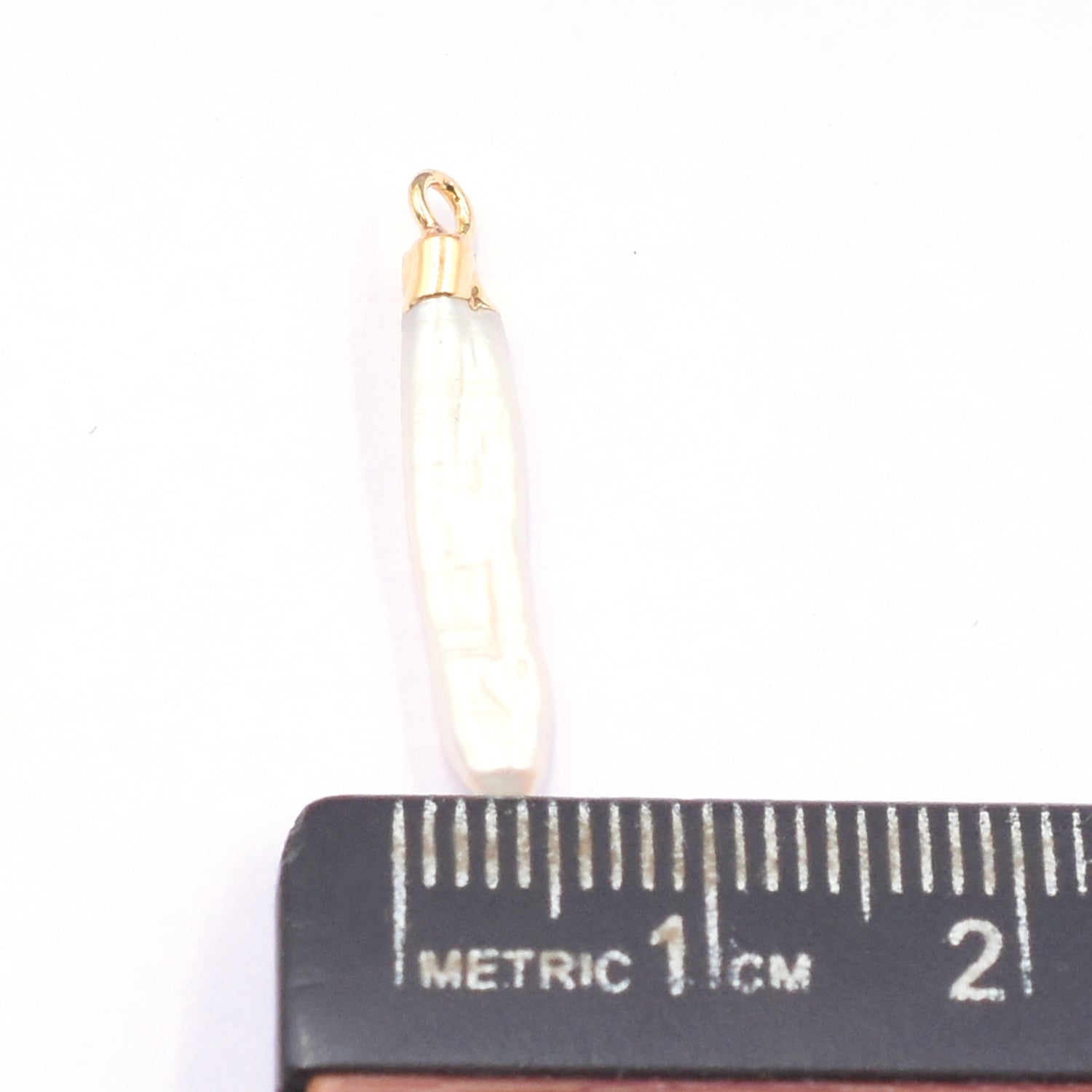 Fresh Water Pearl pendant in pencil shape with gold trim
