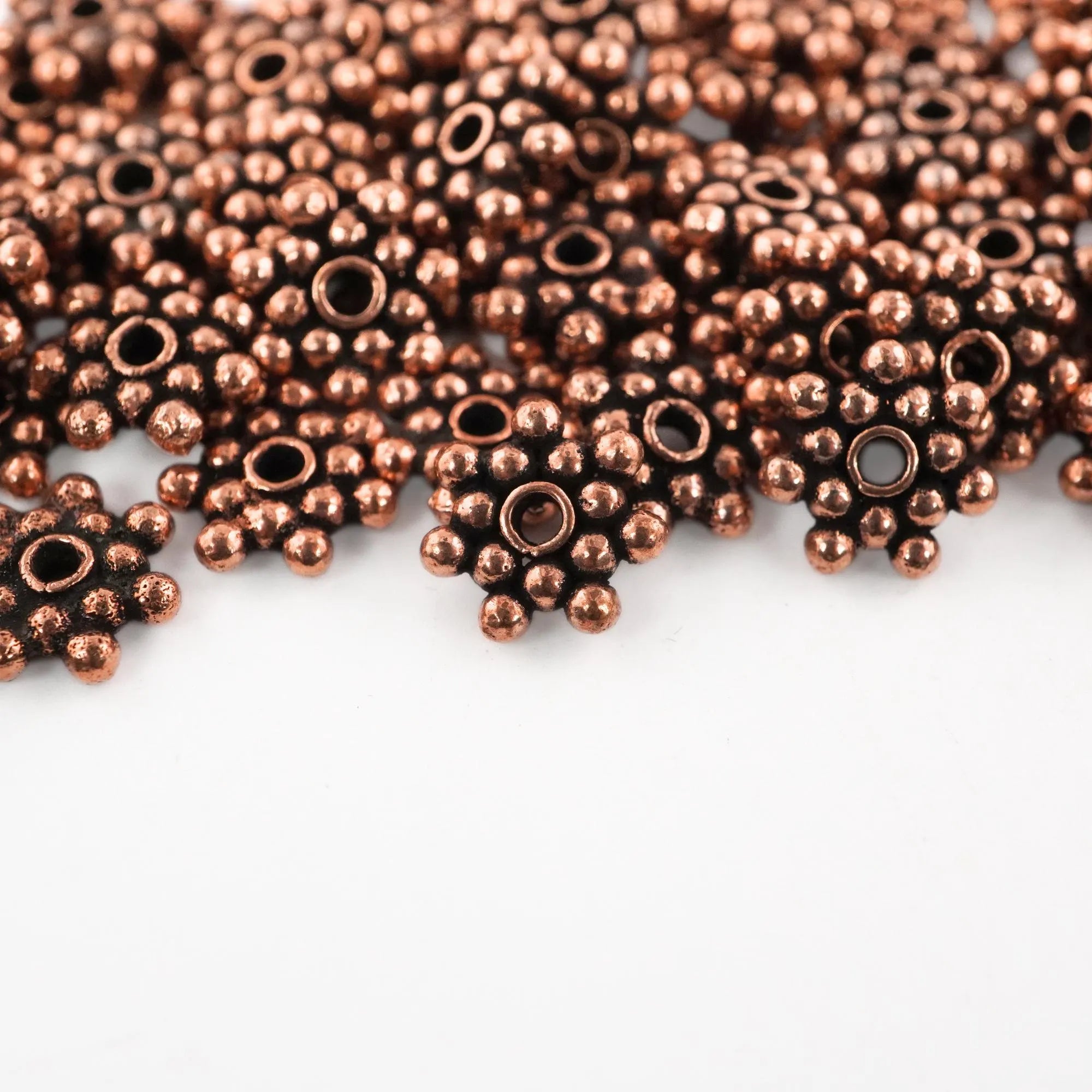 Bulk flower-shaped metal beads

