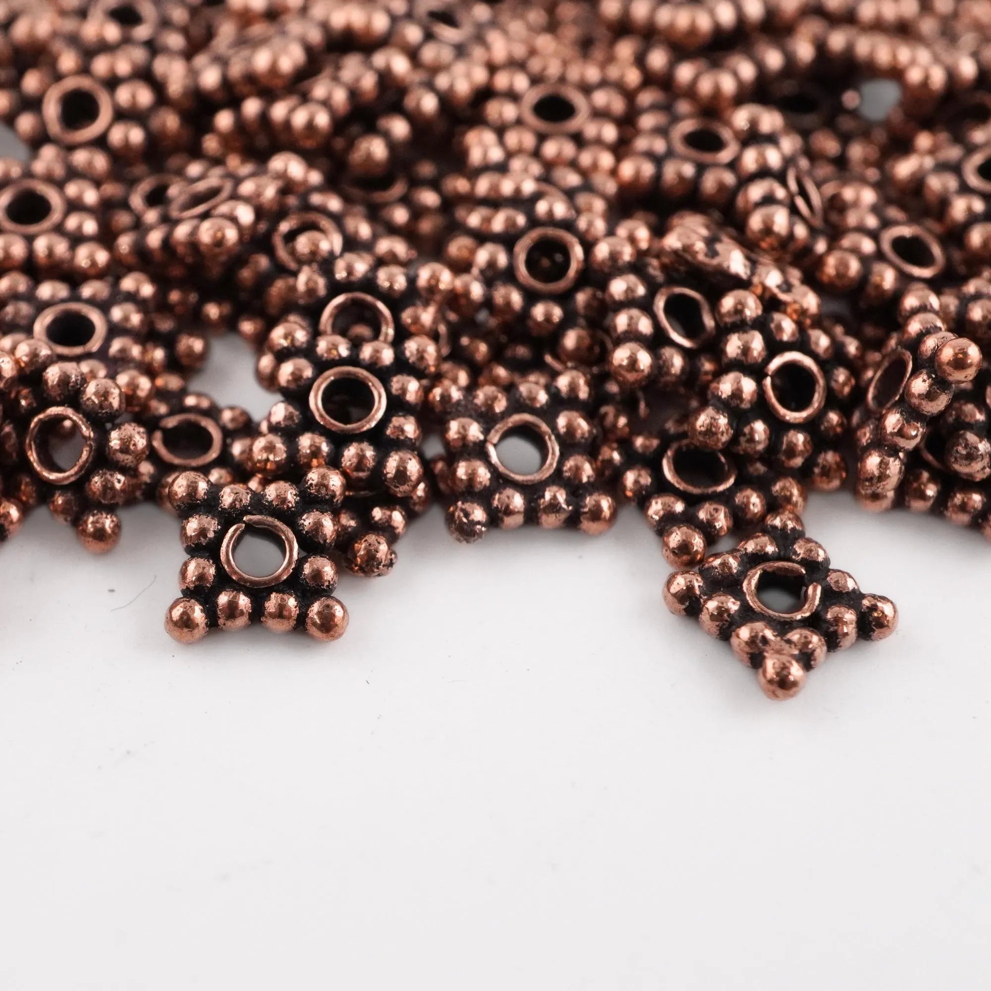 Daisy spacers in antique copper finish

