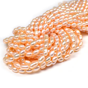 6.5x5.5 - 7.5x5.5 MM Light Peach Rice / Oval Freshwater Pearls Beads