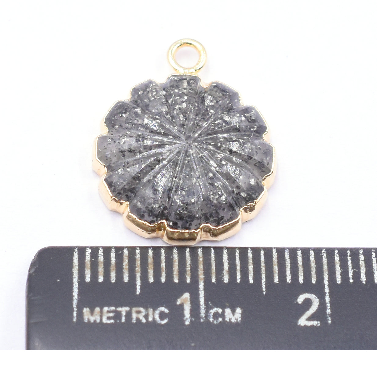 Elegant carved Black Sunstone pendant in round shape with gold detailing